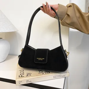 Minimalist black suede crescent bag with gold logo and dual straps for women