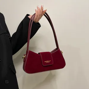 Deep burgundy crescent shoulder bag in frosted suede finish and sleek leather trim