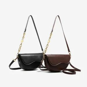 Classic saddle crossbody bags in black and brown with gold chain and irregular flap