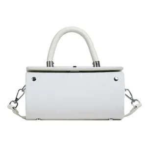 Detail of white baguette bag featuring floral embossed texture and silver hardware
