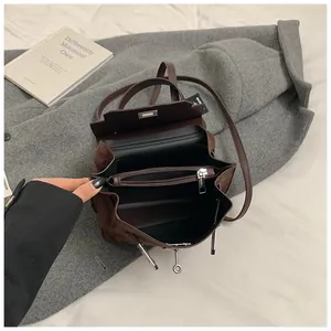 Detail view of the interior compartment with zipper pocket in a brown suede Kelly handbag
