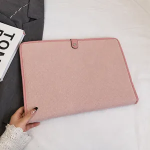 Detail of pink laptop sleeve with woven texture and premium leather piping