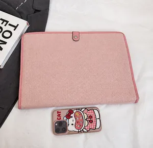Close-up of minimalist pink canvas document bag with metallic snap button and fine texture