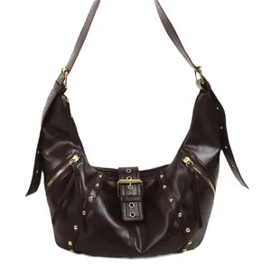 Retro dark brown hobo shoulder bag with studs and tassels on a clean white background