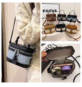 Detailed interior view of a cylinder bucket bag showing storage for phone and makeup