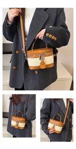 Detail of vintage canvas bucket bag with leather trim and adjustable shoulder strap