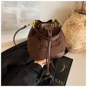 Close-up of plush teddy bucket bag with leather drawstring and embroidered horse logo