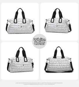 Detail view of white quilted gym bag with glossy finish and detachable shoulder strap