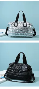 Close-up of quilted waterproof gym bags in metallic silver and black with dual handles