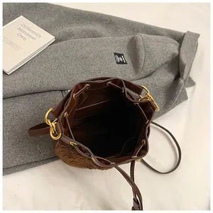 Detailed top view of brown plush bucket bag showing drawstring closure and inner lining