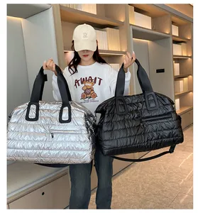 Detail of silver and black quilted gym bags featuring waterproof metallic nylon texture