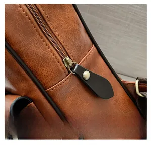 Close-up of smooth metal zipper and textured brown leather on vintage backpack