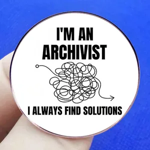 Archivist round metal brooch with 'I always find solutions' text on blue background