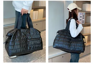 Dual view of a black quilted puffer gym bag with double handles and a shoulder strap