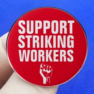 Support Striking Workers enamel badge with red background and fist icon held in hand
