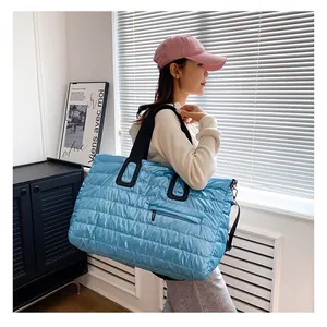 Grand sac fourre-tout matelassé bleu avec anses noires et poche zippée pratique