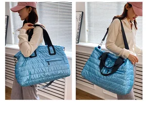 Detail of blue quilted travel bag with waterproof texture and detachable shoulder strap