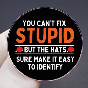 Funny political badge with "You Can't Fix Stupid" text and red hats on black background