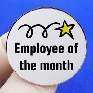Employee of the Month badge featuring a yellow star and meteor design on white metal