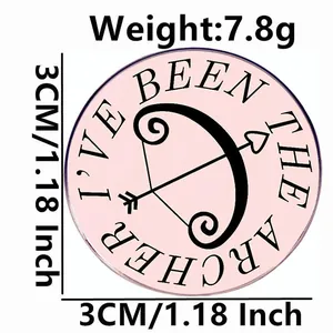 Pink circular 'The Archer' enamel pin brooch, 3cm diameter with metallic bow and arrow