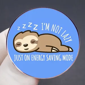 Cartoon sloth brooch in blue metal with I'm not lazy just on energy saving mode text