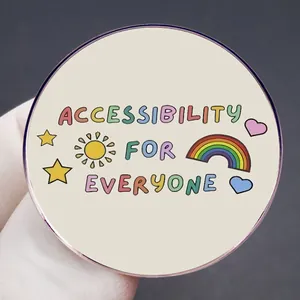 Accessibility for Everyone enamel pin with colorful sun and rainbow on beige metal badge