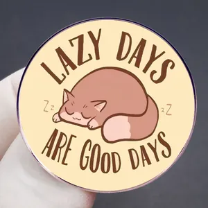 Round acrylic brooch with a sleeping brown cat and 'Lazy Days Are Good Days' quote