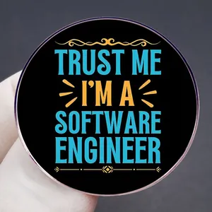 Round black enamel brooch with Trust Me I'm A Software Engineer text and gold metal trim