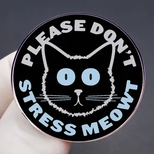 Cartoon black cat enamel pin badge with 'Please Don't Stress Meowt' text held by hand