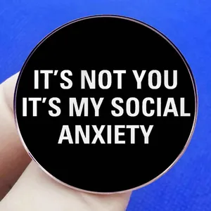 Round pin badge featuring It's Not You It's My Social Anxiety text on black background