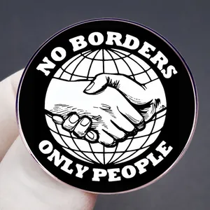 No Borders Only People enamel pin featuring handshake and earth design on metal badge