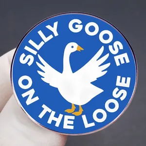 Cartoon white goose enamel pin badge with Silly Goose on the Loose text on blue background