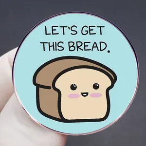 Funny cartoon bread brooch with Let's Get This Bread text on light blue background