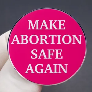 Make Abortion Safe Again badge pin in rose pink enamel with bold white lettering