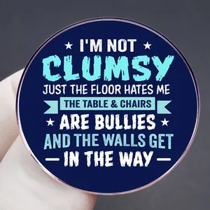 Funny blue round enamel pin with 'I'm not clumsy' quote for accessories and clothing