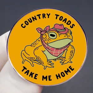Cartoon frog enamel pin with cowboy hat featuring Country Toads Take Me Home text