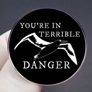 Taylor Swift inspired seagull brooch with You Are In Terrible Danger slogan in enamel