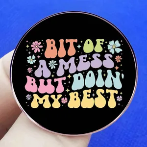 Round brooch badge featuring Bit Of A Mess But Doin My Best inspirational floral design