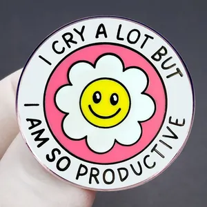 Round enamel pin with flower smiley face and I cry a lot but I am so productive slogan