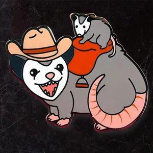 Detailed view of enamel cowboy opossum pin with a tiny possum riding on a red saddle