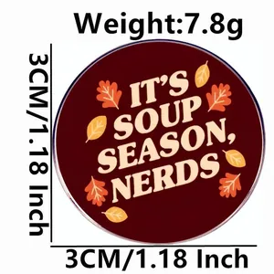 3cm round enamel pin with Its Soup Season Nerds text and autumn maple leaves design
