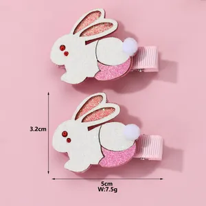 Detail of pink rabbit hair clips with plush texture and size specs 5cm by 3.2cm