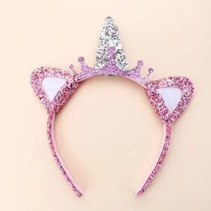 Detail of pink sequin crown and silver unicorn horn on a children's headband