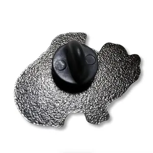 Detail of the back of the metal opossum pin showing silver texture and black rubber clutch