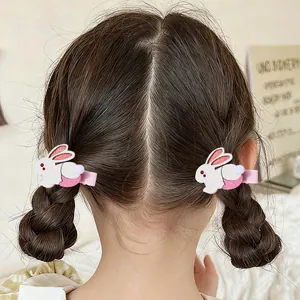Pair of cute white cartoon bunny hair clips for kids on pink ribbon lined alligator clips
