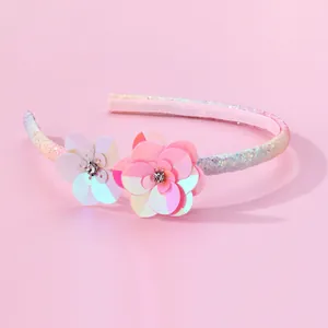 Rainbow glitter kids headband with sequin flowers and rhinestones on pink background