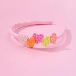 Girl's pink glitter headband with five colorful 3D hearts for daily or party wear