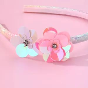 Pink girls' floral headband with sequin flower details and rainbow glitter finish