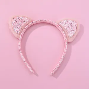 Detailed view of pink cat ear headband with plush fur and shimmering colorful sequins