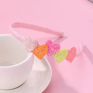 Pink glitter girls headband featuring five colorful sequin hearts and non-slip grip